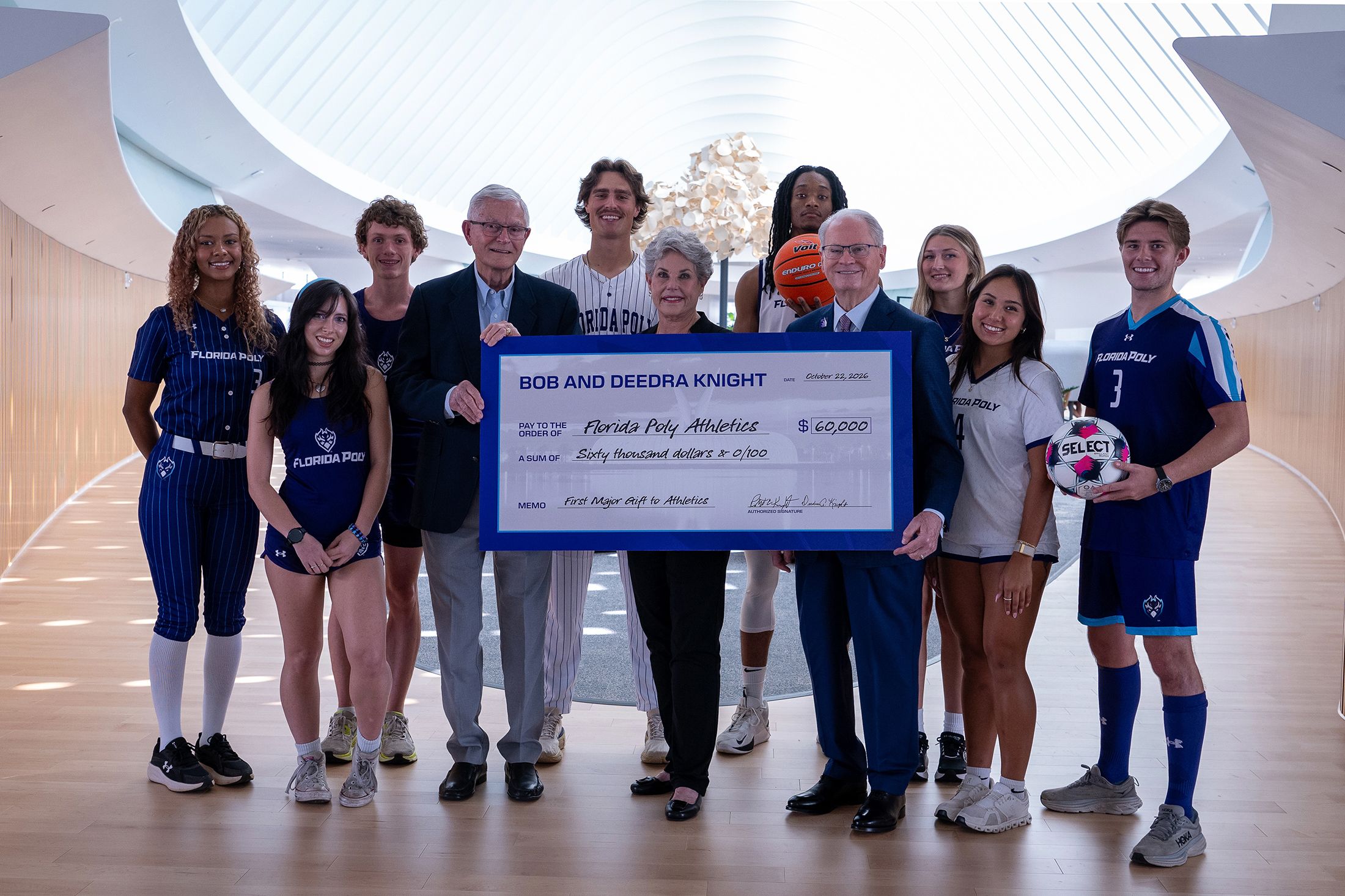 Bob and Deedra Knight join Florida Poly President Devin Stephenson and student-athletes to celebrate a $60,000 athletics donation.