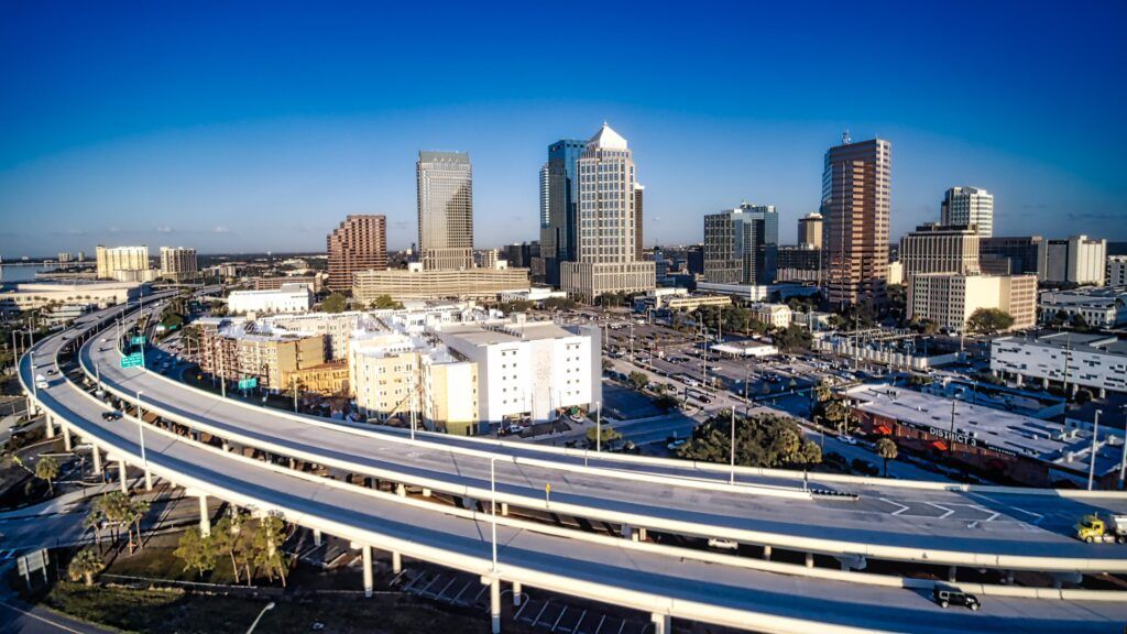 Aerial view of the Lee Roy Selmon Expressway curving past downtown Tampa high-rise buildings, where a $362 million expansion is underway.