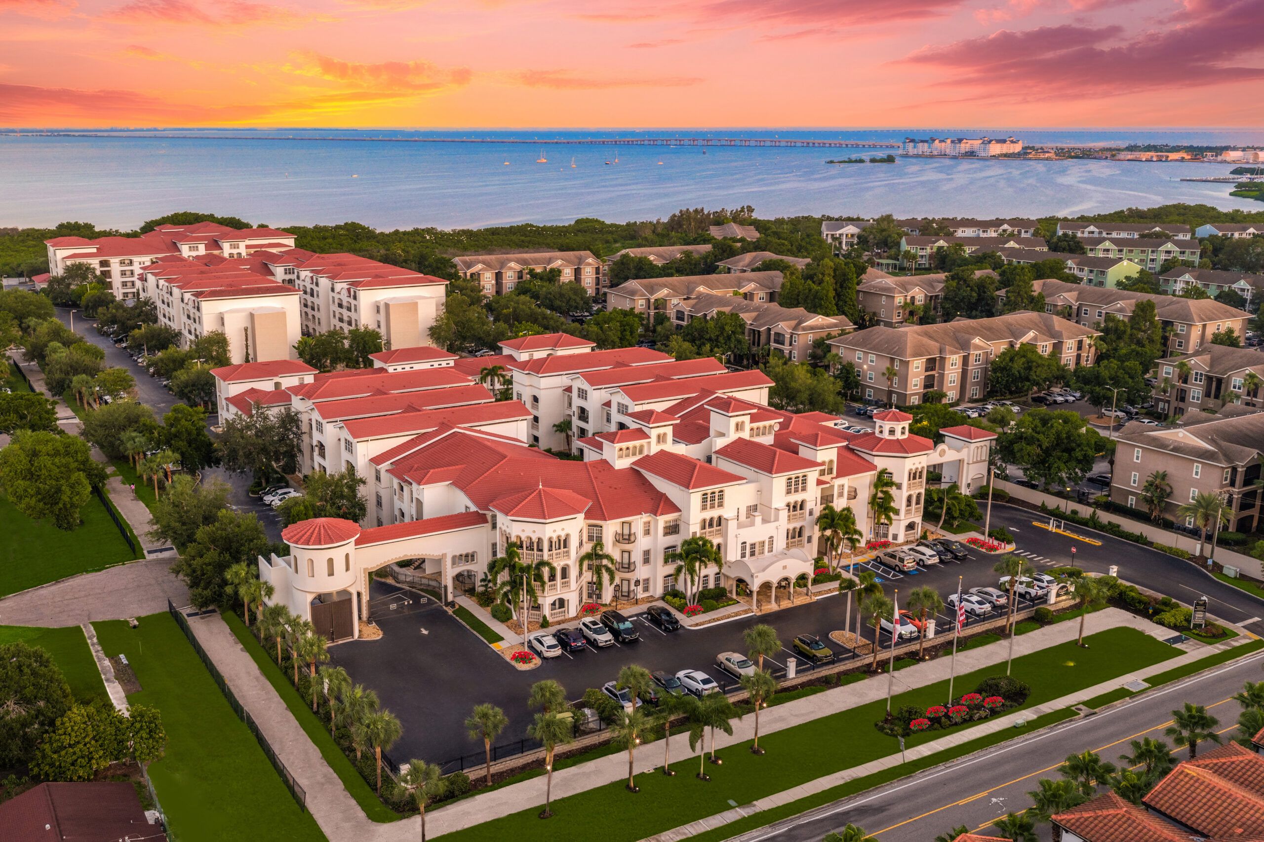 Aerial view of Casa Bella on Westshore apartment complex in South Tampa, featuring red-roofed buildings along Tampa Bay.