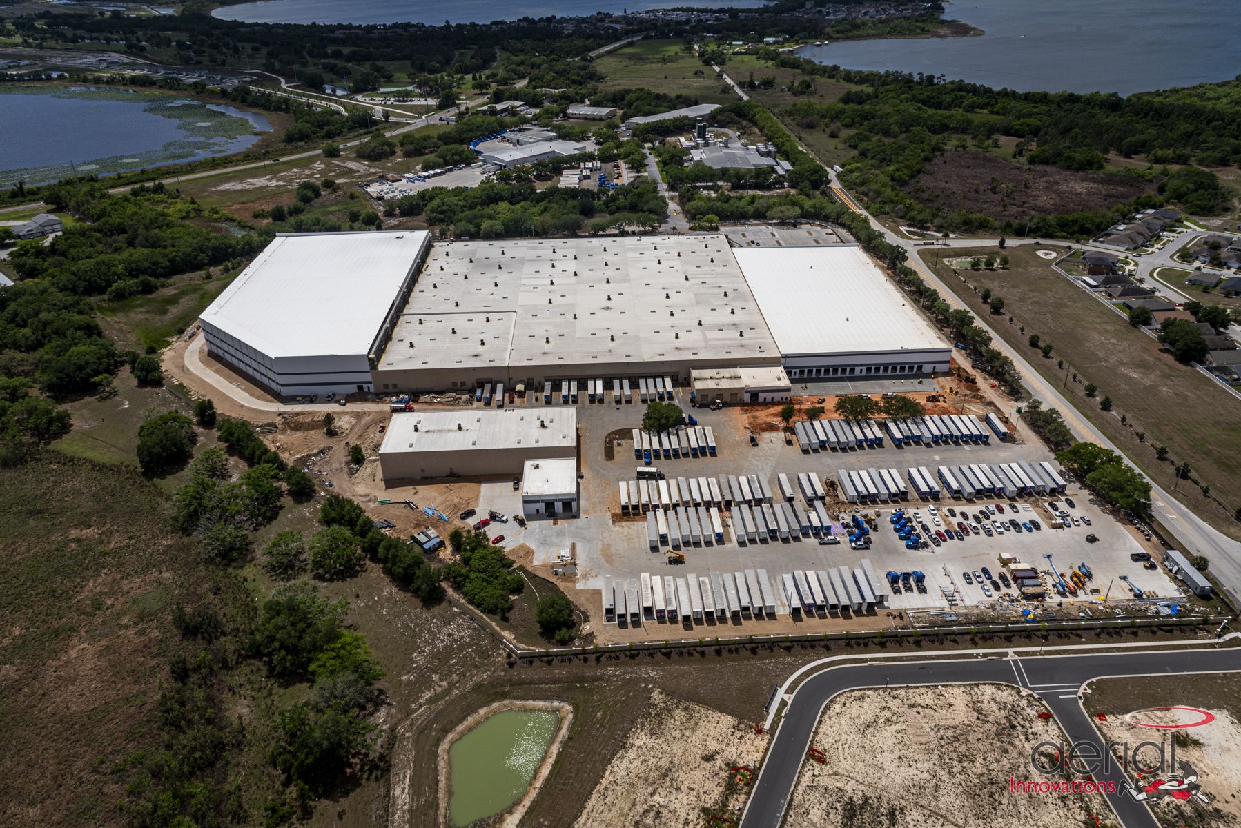 Aerial view of the 685,000-square-foot Sherwin-Williams distribution center in Winter Haven, Florida, with loading docks and truck trailers.